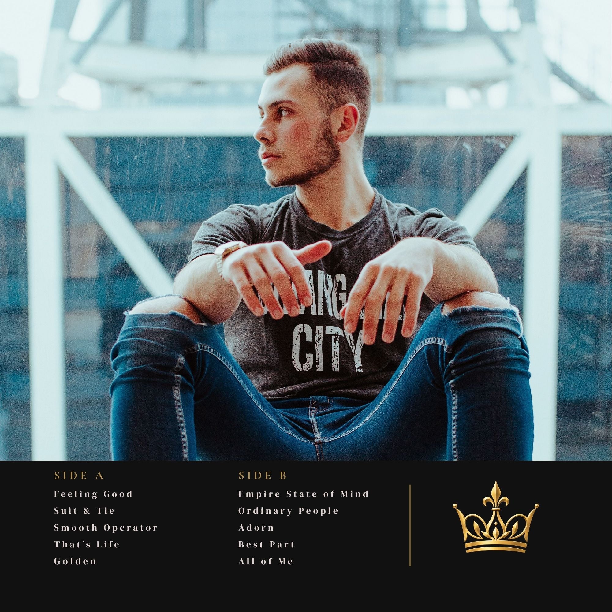 Album cover for 'Ang City' featuring a man sitting in a modern industrial setting, wearing a dark gray graphic t-shirt and blue jeans. The bottom of the image features a black tracklist banner with song titles and a gold crown logo.