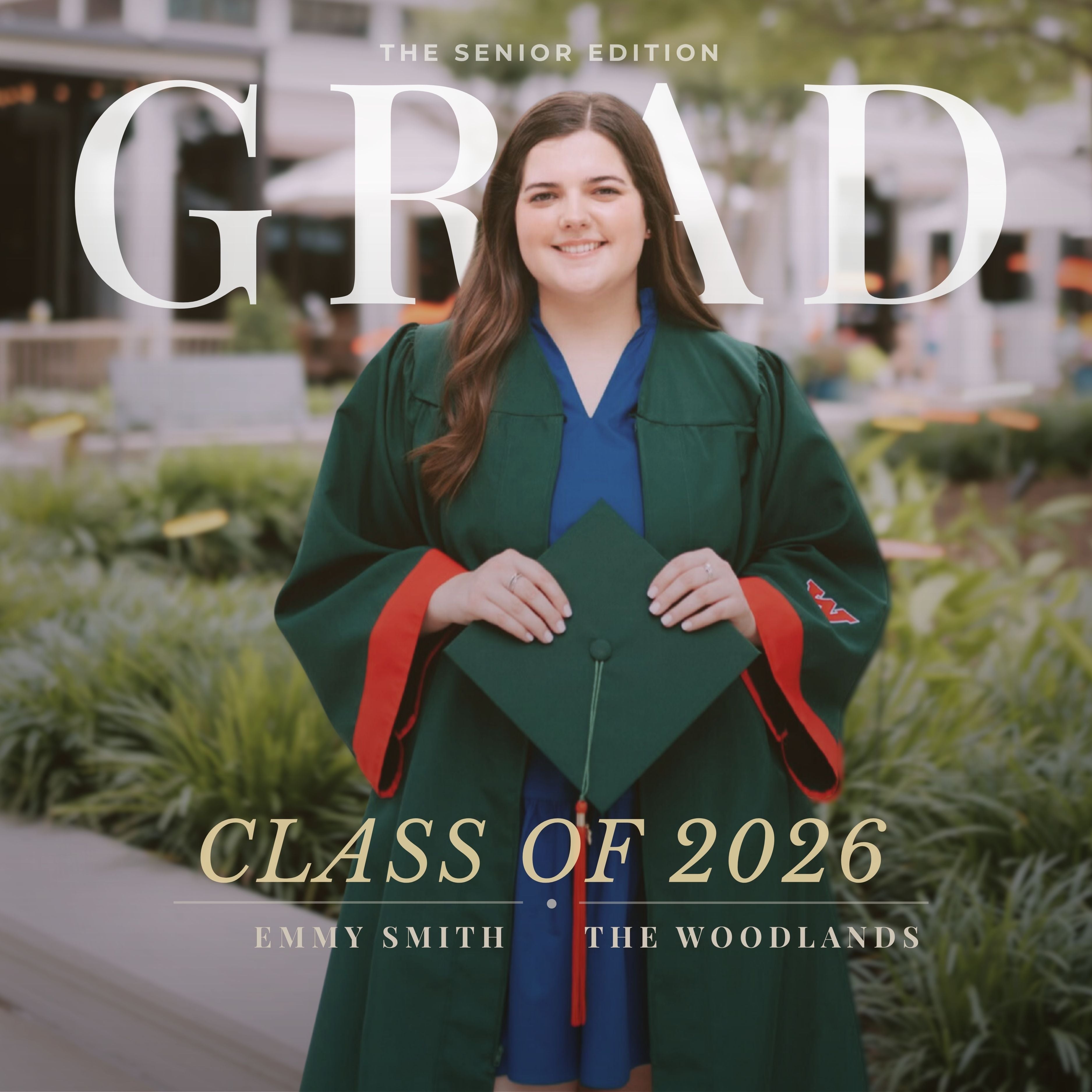 A woman in a green graduation gown and cap stands outdoors holding a graduation cap, with large overlaid text reading 'GRAD', 'CLASS OF 2026', and 'EMMY SMITH THE WOODLANDS'. This is a lifestyle-style promotional image rather than a clean product shot, and the gown is the likely product context.