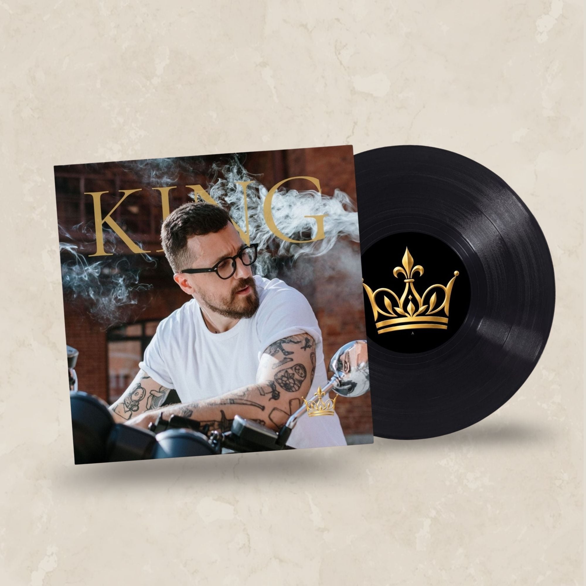 A vinyl record partially pulled from its sleeve, shown on a light beige textured background. The album cover features a man with tattoos and glasses, with the word 'KING' in gold lettering and smoke effects.