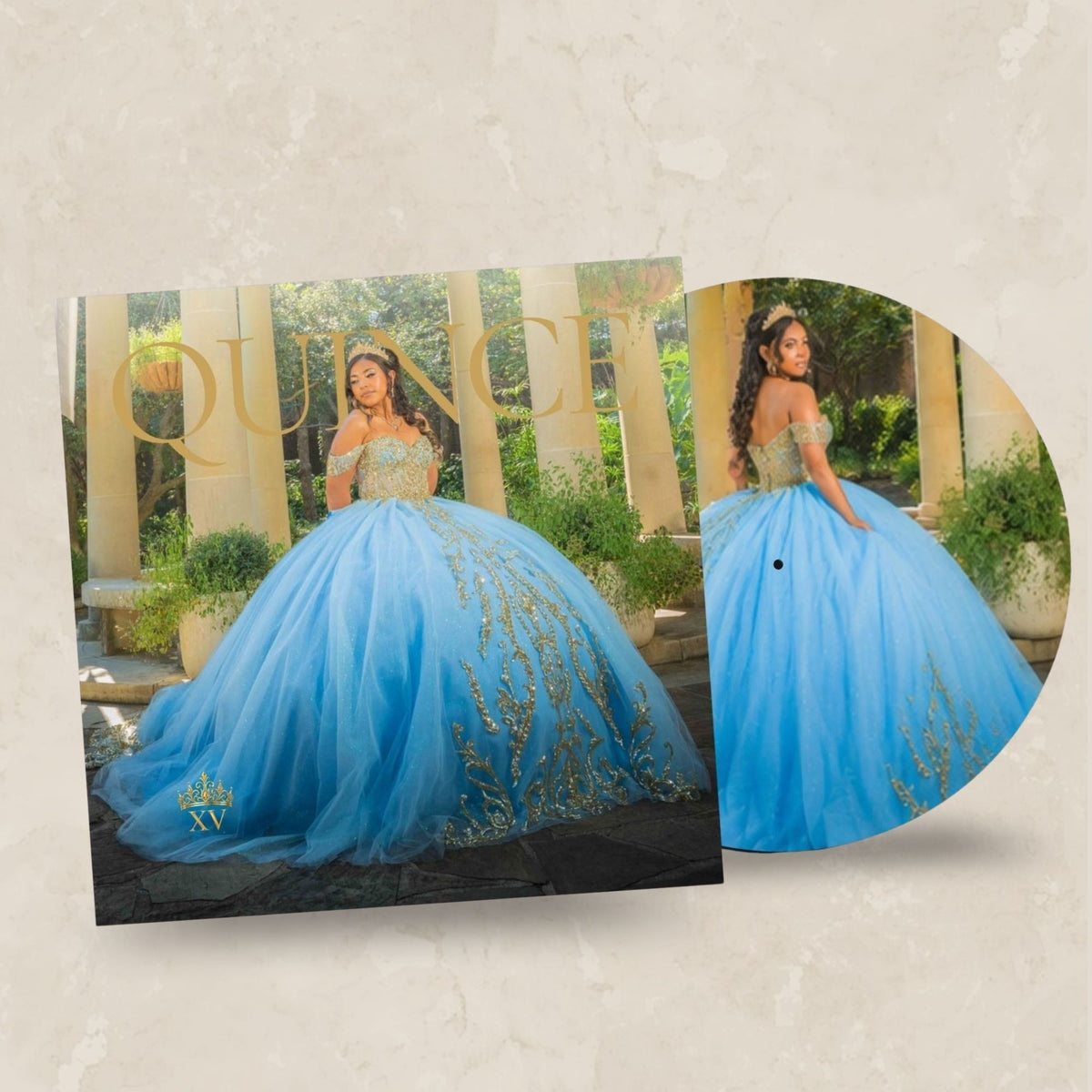 A blue quinceañera ball gown with gold embroidery is shown on a beige textured background, alongside a circular printed insert featuring a model wearing the gown and the word 'QUINCE' in gold.