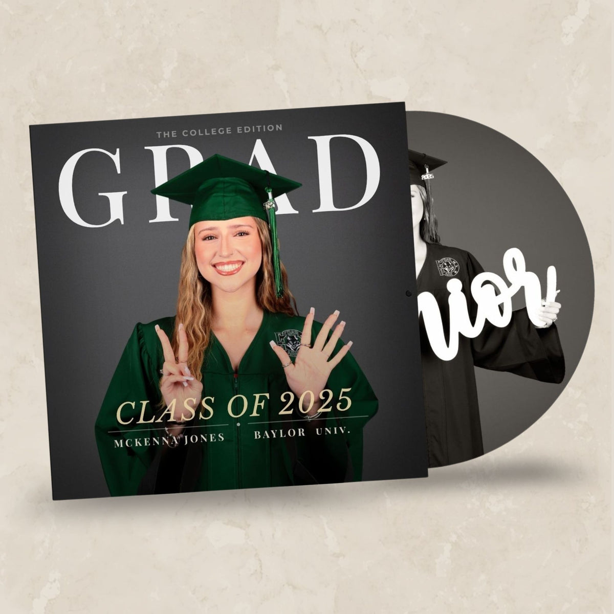 A custom vinyl record album cover and matching record sleeve for a graduation commemorative item. The square album cover features a smiling woman in a green graduation cap and gown making peace signs, with large white 'GRAD' text and 'CLASS OF 2025' on a dark charcoal background.